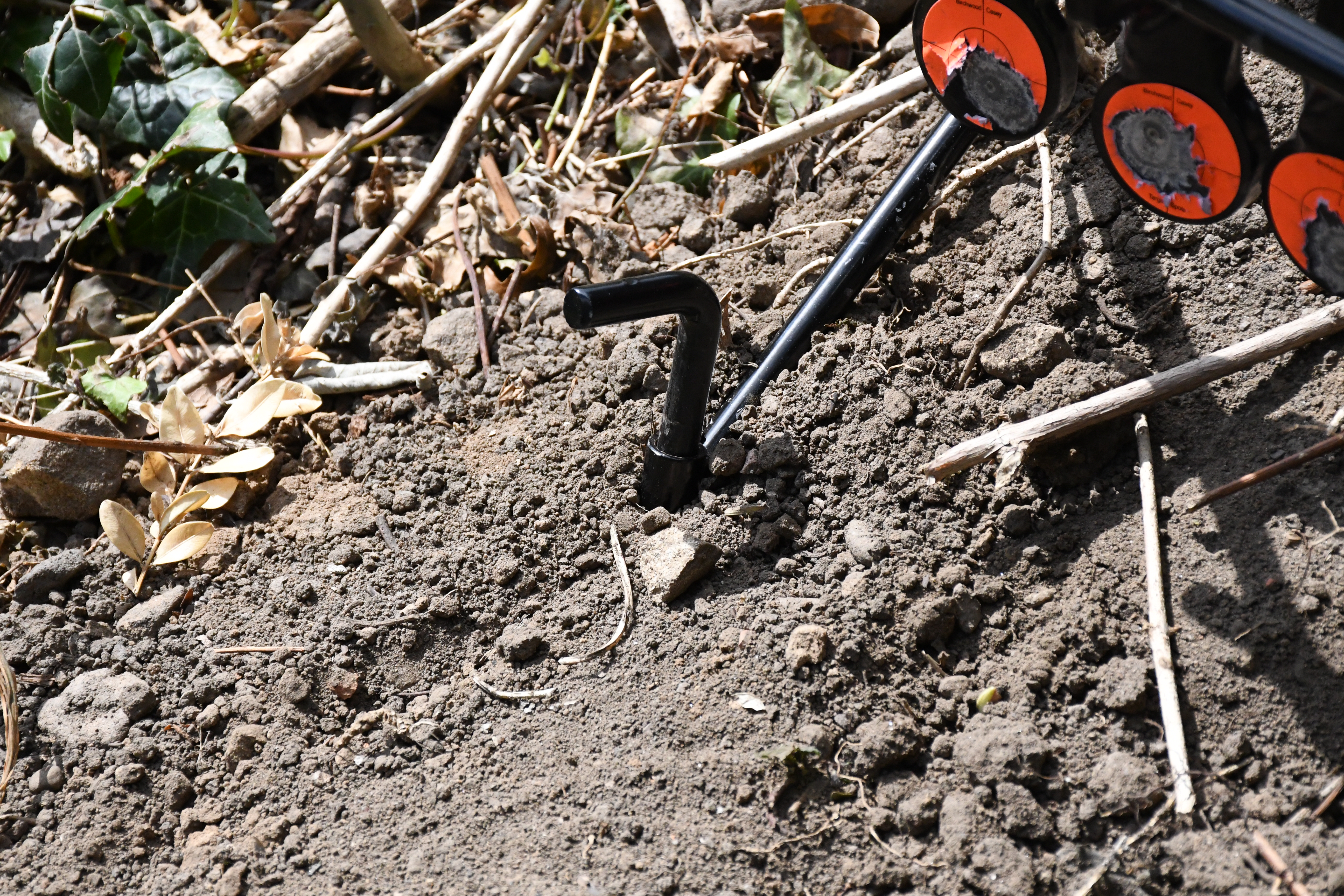 The surface of the steel target showing minor marks and impacts after use with .22LR ammunition.