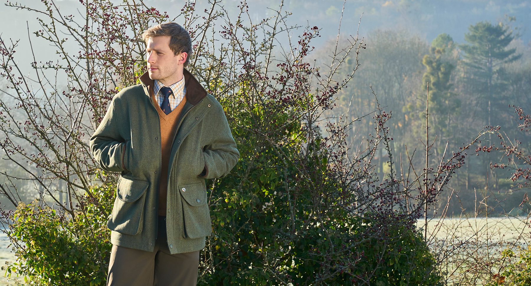 Alan Paine Combrook tweed shooting coat worn in a frosty field