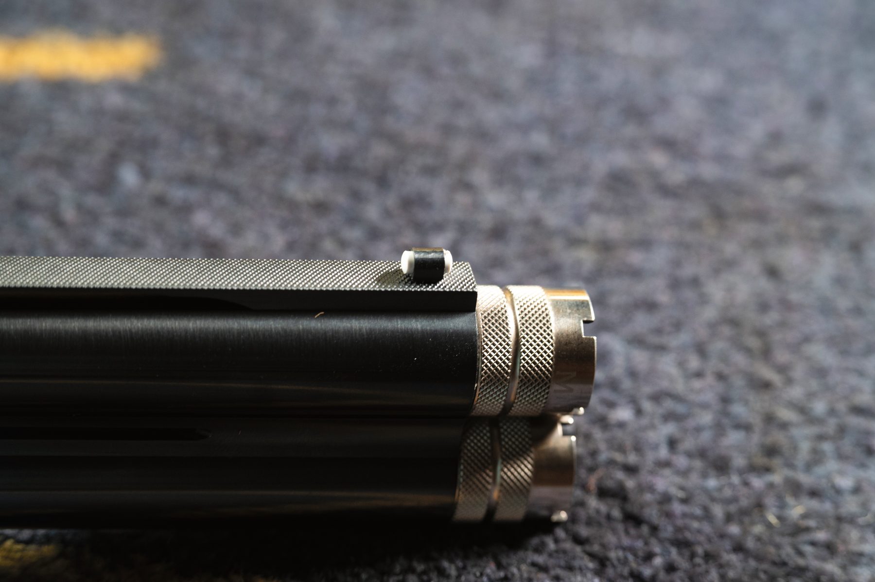 The muzzles of the Beretta 687 500 Years LE Sporter showing the knurled extended chokes