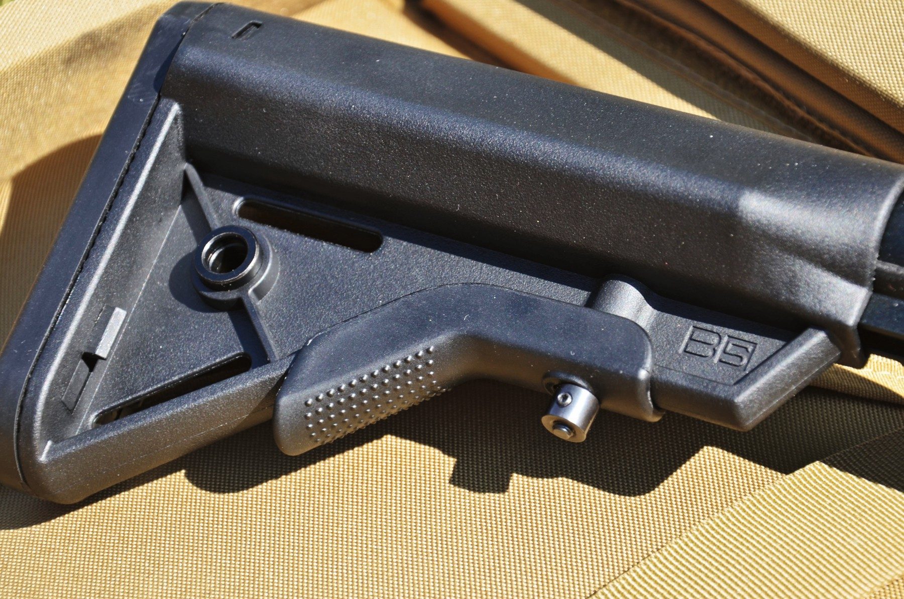 The spring-loaded catch on the underside of the BSA XT-SL buffer tube that sets length of pull