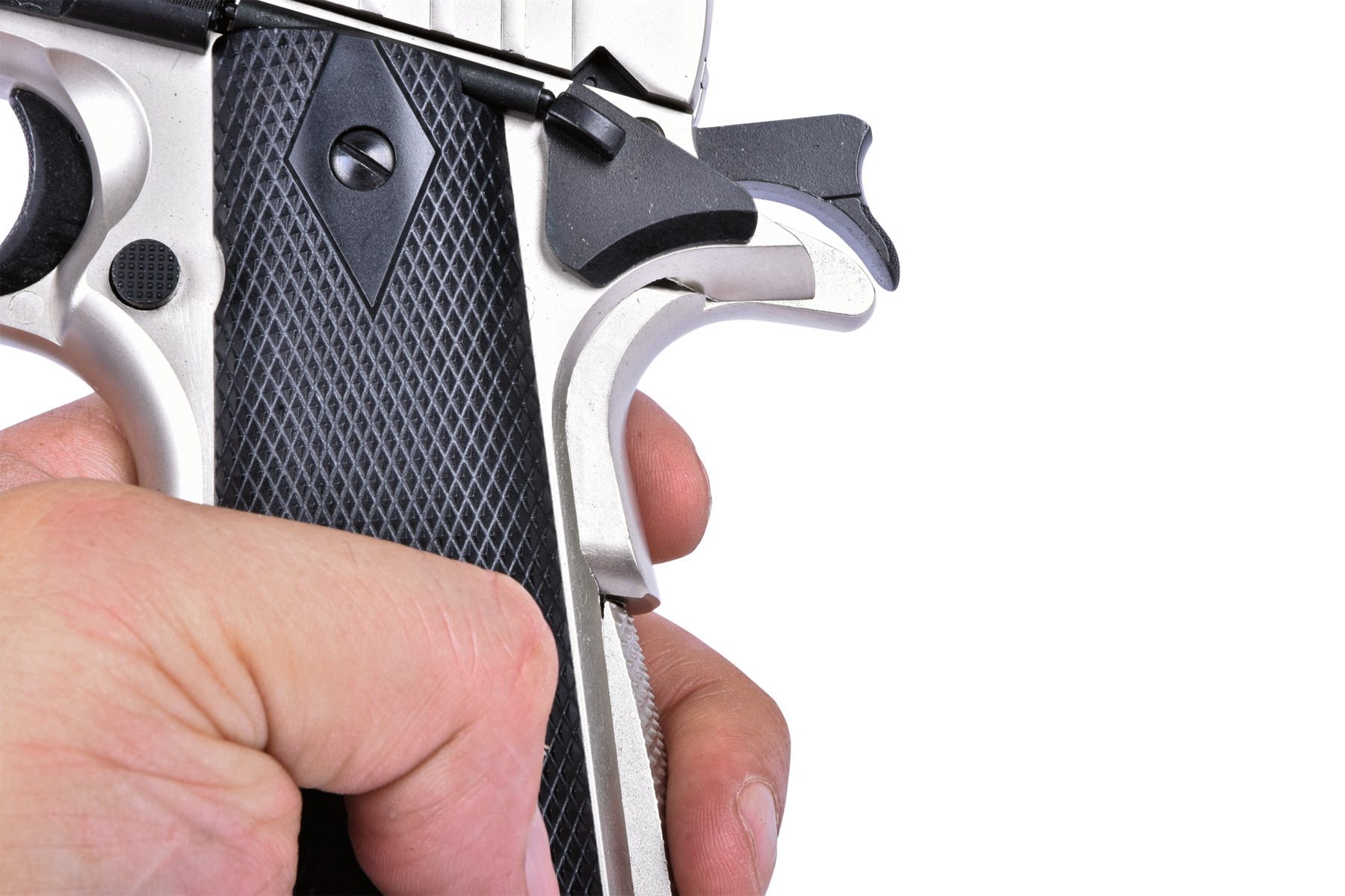 A hand gripping the Ekol ES1911, depressing the grip safety behind the thumb