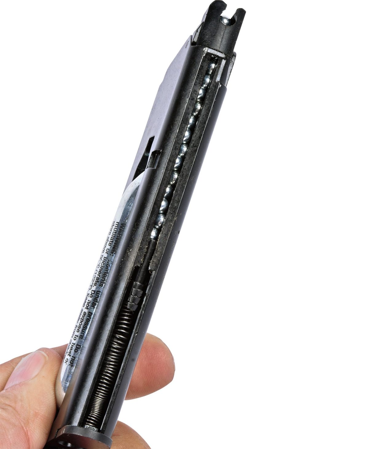 The Ekol ES1911 magazine loaded with steel BBs held under spring tension