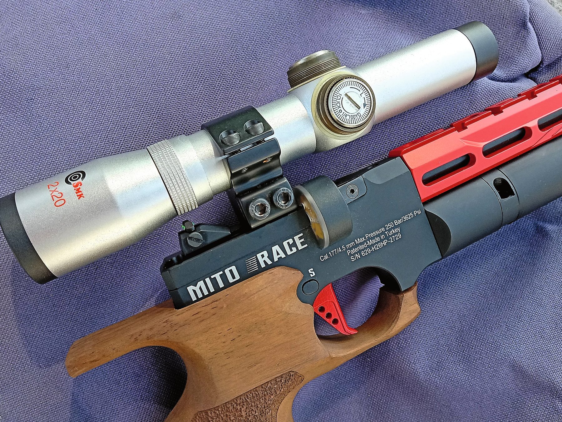 The Reximex Mito Race fitted with a 2x pistol scope on its 11mm dovetail rail