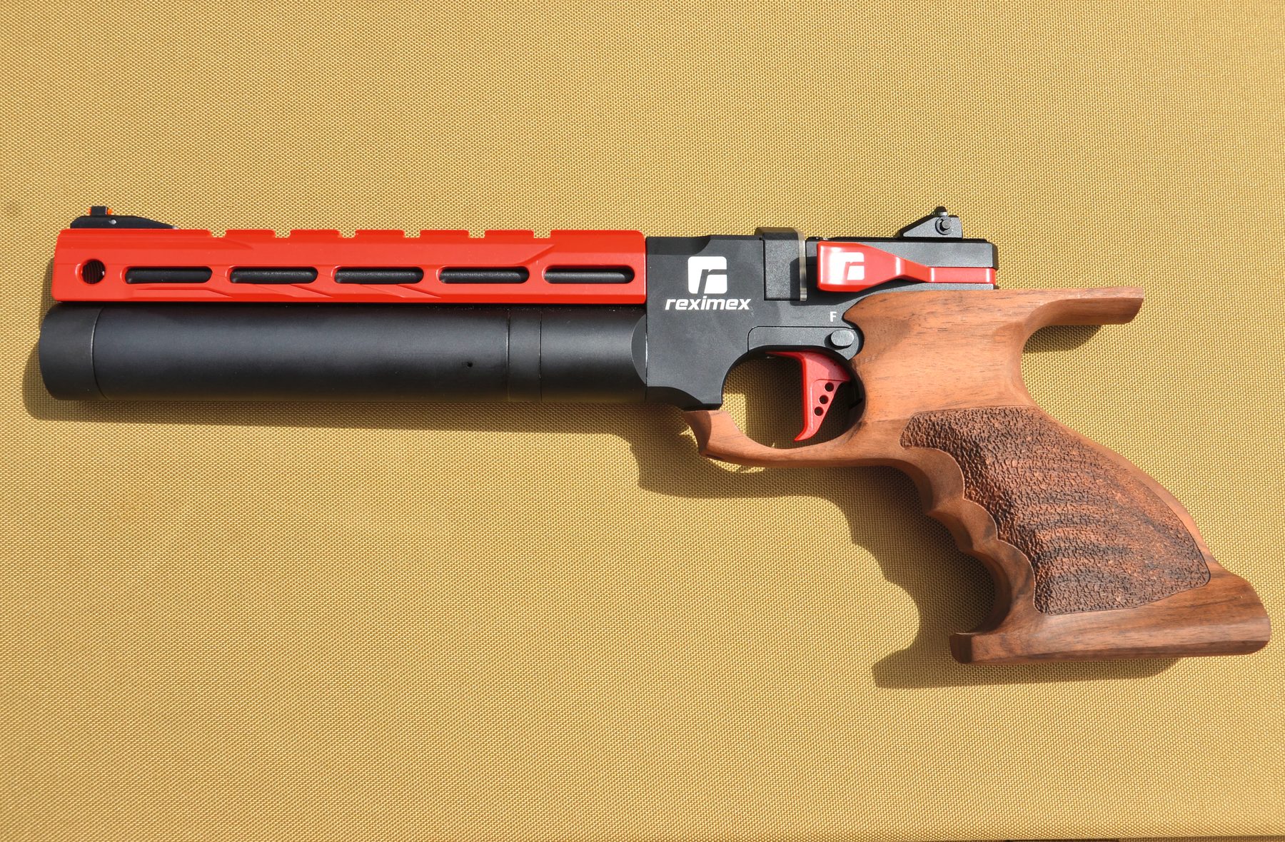 The Reximex Mito Race air pistol with its orange skeletonised shroud and Turkish walnut grip