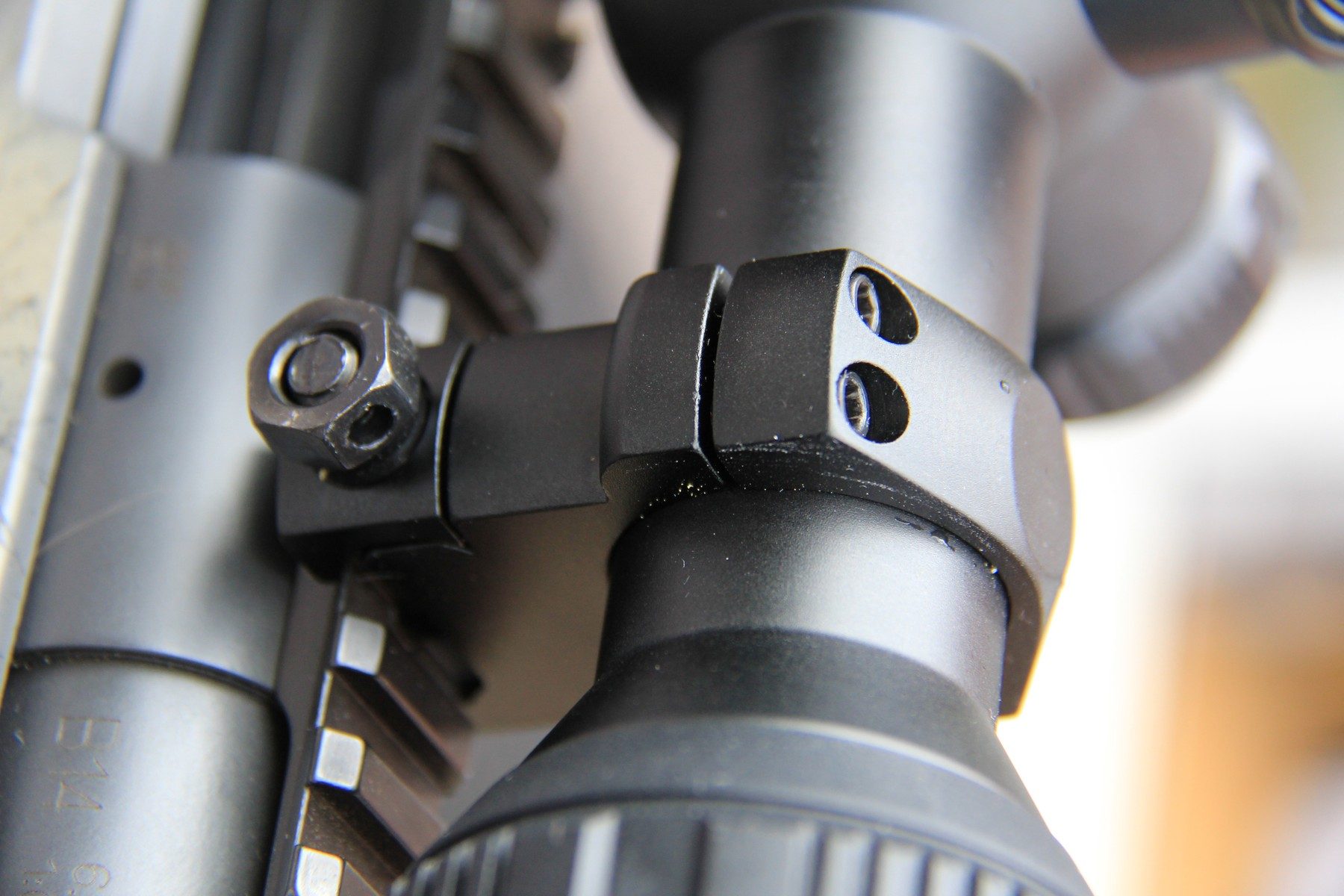 Close-up of the two-piece 30mm scope ring mounting the RIX Tourer T50 4K to a Picatinny rail