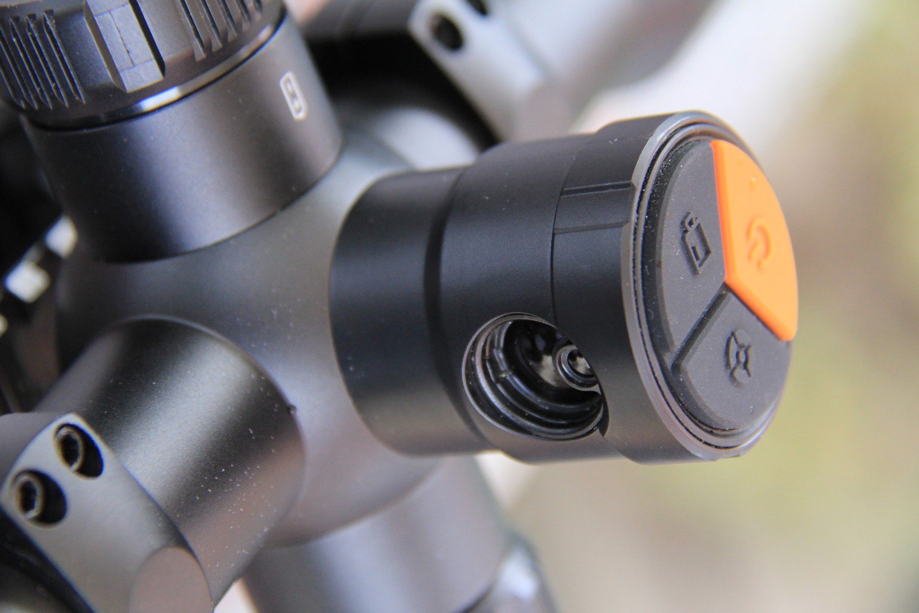 The left-hand turret of the RIX Tourer T50 4K with its orange-marked menu button and zoom wheel
